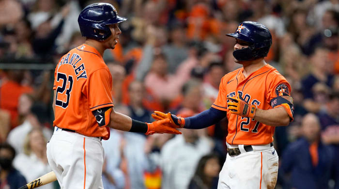 Oct 27, 2021; Houston, TX, USA; Houston Astros second baseman Jose Altuve (27) celebrates with left fielder Michael Brantley (23) after hitting a solo home run against the Atlanta Braves during the seventh inning in game two of the 2021 World Series at Minute Maid Park.
